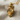 King lion crown pendant, gold vermeil, angled view on fabric