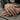 Oxidized silver dumbbell ring worn on a man's hand outdoors, showcasing the bold fitness and weightlifting design