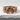 Overlapping Pebble Ring, rose plated silver, front view on white stone
