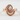 Curling Wave Ring, rose gold, front view on textured surface