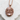 Baby girl pendant, rose gold plated silver, front view on stone