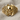 Frontal view of ornate skull ring resting on textured fabric showing deep engravings and striking skull centerpiece