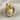 Angled side profile of gold vermeil wolf head ring resting on textured fabric highlighting band design