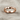 Faceted Rhombus Ring, rose gold, front view resting on textured linen