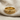 Swirling Vine Ring, gold vermeil, resting on linen fabric