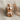 Teddy bear pendant in rose gold, front view on fabric