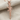 Assault Rifle Pendant, rose gold, front view on fabric