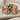 Embracing Wings Ring, rose gold plated, front view on linen