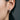 Close-up of woman wearing the weathered hoop earring showcasing the ancient excavated artifact texture and finish