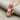 Electric Mouse Pendant, rose gold, angled three-quarter view on fabric
