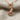 Descending Panther Pendant, rose gold, front view on linen