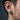 Side profile of man wearing two-tone oxidized silver and gold phoenix stud earring showcasing size and styling