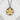 Close-up of the handcrafted cherry blossom pendant on a white stone surface highlighting the intricate petal relief.
