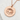Hammered Lotus Blossom Pendant, rose gold finish, front view on stone background