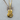 Close-up of the acoustic steampunk guitar pendant resting on a textured wooden slice highlighting gear details