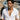 Handsome male model wearing the royal flush pendant on a gold chain outdoors by a boat with an open white linen shirt