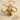 Close-up of the Anubis Bastet pendant resting on a sandy beach surrounded by small sea shells highlighting rich details