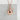 Takoyaki octopus ball pendant, rose gold plated silver, on concrete display
