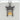 Close-up of two-tone Mount Fuji torii pendant resting on a textured concrete block highlighting gold details.