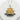 Close-up of the sterling silver Golden Pavilion pendant resting on a white stone highlighting its intricate gold details