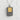 Close-up of the two-tone vending machine pendant showing intricate gold vermeil bottles and silver coin slot.