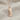 Luwian Life Hieroglyph Earring, rose gold, front view on fabric