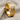Hexagonal moon crater ring, gold vermeil, angled product photo on fabric