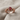 Bat Engagement Ring, rose gold, front view on textured cloth