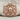 Pirate Crossbones Skull Ring, rose gold, front view on textile fabric