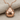 Domed ladybug beetle pendant, rose gold plated silver, front view on fabric