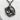 Close-up of gothic raven book pendant resting on white stone highlighting the intricate oxidized silver finish