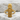 Front view of victorian gold vermeil rose ring resting vertically on textured white marble