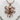 Sprawling octopus pendant, rose gold, front view on white stone surface