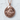 Santa Claus Medallion Pendant, rose gold finish, product photo against wall