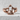 Half Skull Jaw Ring, rose gold finish, front view on stone surface