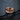 Sapphire Crater Ring, rose gold finish, front view on dark surface