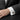 Close-up of Masonic enamel cufflinks worn on a white French cuff shirt showing formal business attire