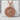 Saint George Laurel Pendant, rose plated silver, front view on stone block