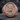 Saint Michael Battle Signet Ring, rose gold finish, front view on rock surface