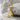 Brutalist Shard Earring in gold vermeil, angled view on rock