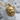 Snarling Cat Medallion Pendant, gold vermeil, angled view on stone