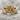 Secret Whisper Ring in gold vermeil, front view on stone surface