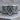 Masonic Scroll Ring, oxidized, front view on wood surface