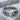 Molten droplet open ring, oxidized silver, front view on stone pedestal