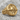 Adam Skull Ring, gold vermeil, product photo on rock surface