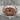 War Signet Ring, rose gold, front view on stone surface