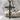 Timber crucifix pendant in black rhodium plated finish, front view on stone