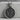 Dragon and Phoenix Medallion Pendant, oxidized finish, front view on stone pedestal