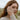 Redheaded woman wearing open celtic knot ring on hand with coastal background and brand text overlay