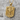 Bundesadler shield pendant, gold vermeil, angled product photo on stone